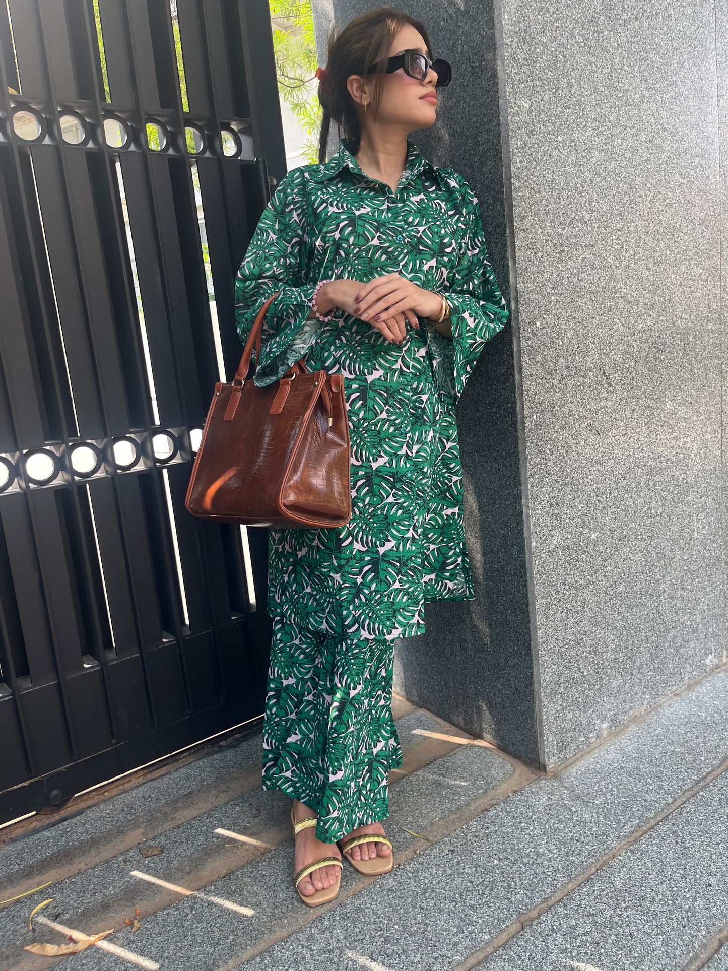 Model wearing BEGUM'S Tropical suit set – a vibrant, summer-ready co-ord in refreshing citrus and floral tones, featuring a relaxed fit, statement sleeves, and breezy cotton fabric. Perfect for daytime outings and monsoon getaways.