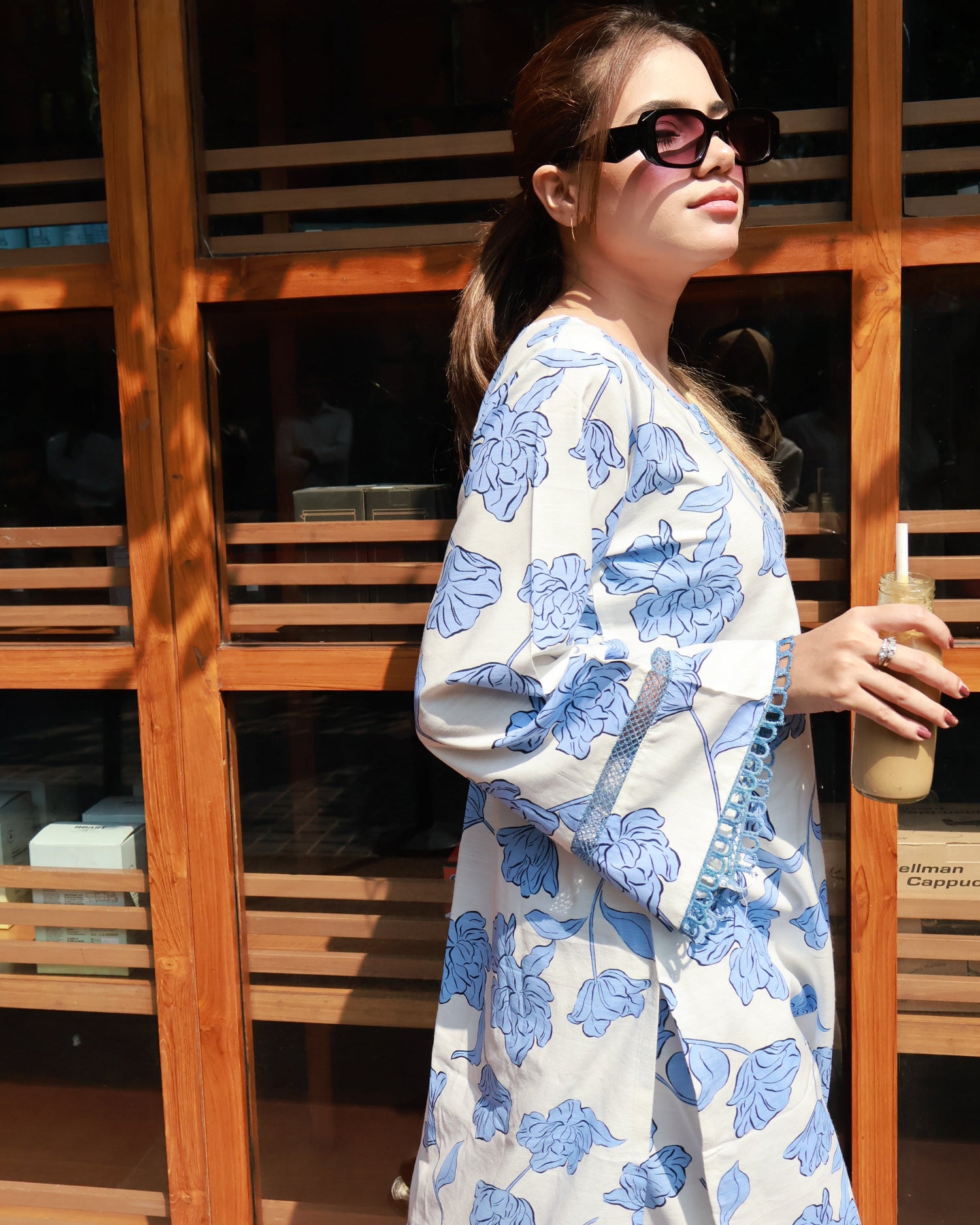 Woman modeling BEGUM’S Summer Floral Kurta Set—pastel multi-colour florals on breathable pure-cotton kurta with lace-trimmed bell sleeves and cropped straight pants for effortlessly elegant summer wear.